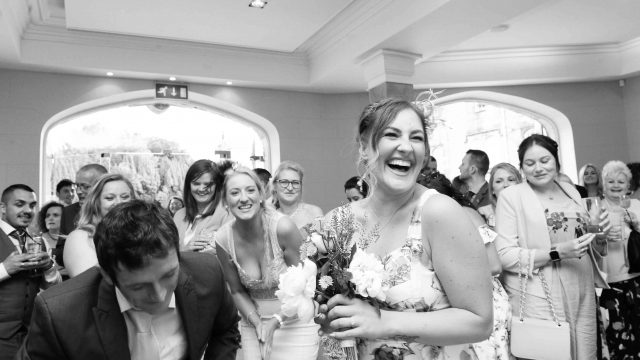 image of girl catching a bouquet at a wedding